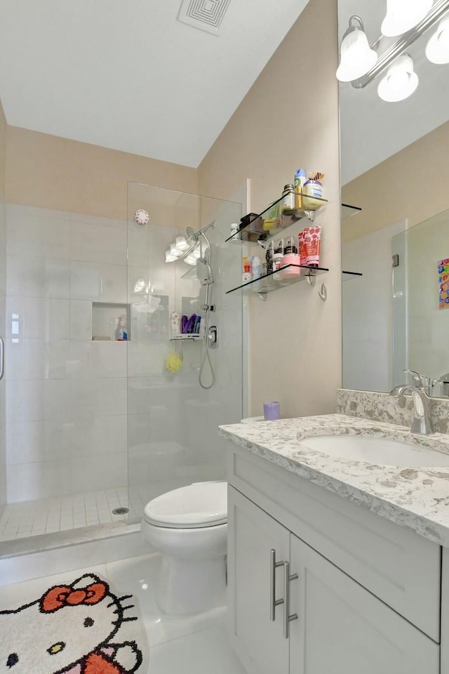 bathroom featuring walk in shower, vanity, and toilet