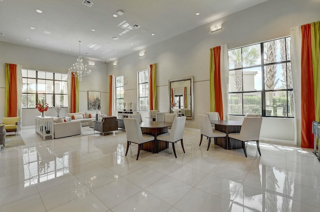 dining space featuring light tile patterned flooring, a wealth of natural light, and a chandelier