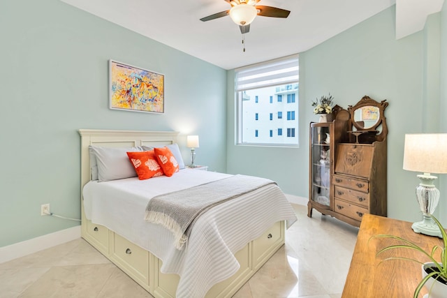 tiled bedroom featuring ceiling fan