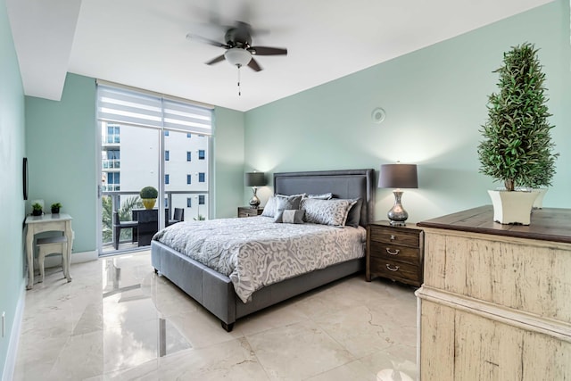 bedroom with access to exterior, a wall of windows, and ceiling fan