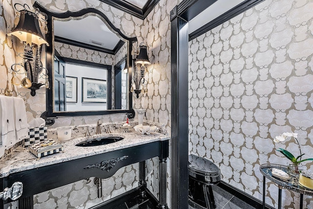 bathroom featuring ornamental molding, toilet, tile patterned flooring, and sink