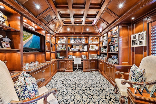 interior space featuring built in desk, wooden walls, coffered ceiling, crown molding, and light carpet