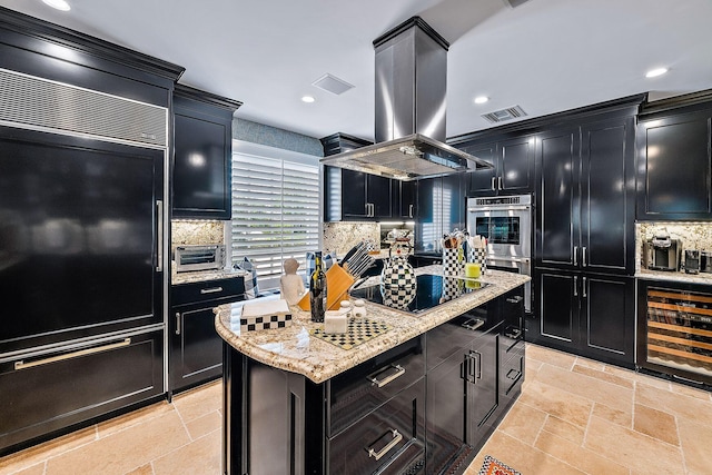 kitchen with island range hood, beverage cooler, a center island, stainless steel double oven, and black electric cooktop