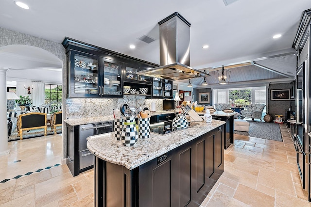 kitchen with light stone counters, a center island, black electric cooktop, island exhaust hood, and decorative backsplash