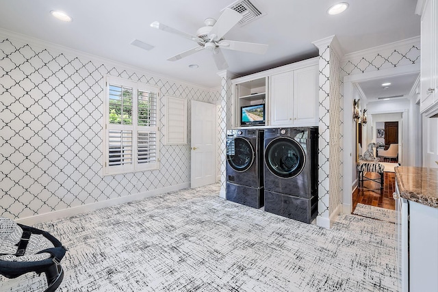 laundry area featuring ceiling fan, cabinets, ornamental molding, and washing machine and dryer