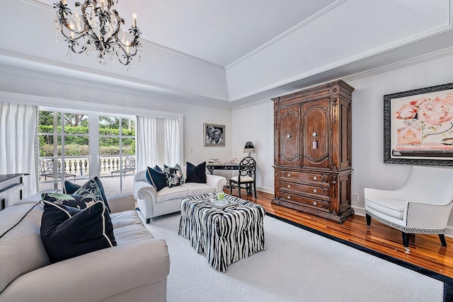 living room with ornamental molding, light hardwood / wood-style flooring, and a notable chandelier