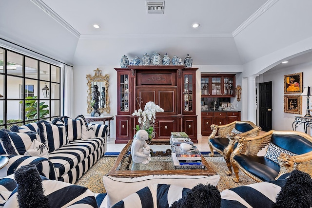 living room with ornate columns, crown molding, lofted ceiling, and indoor bar