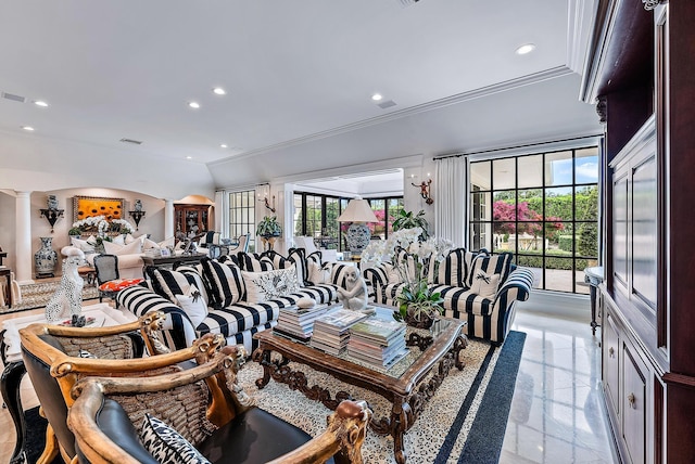 living room featuring vaulted ceiling and decorative columns