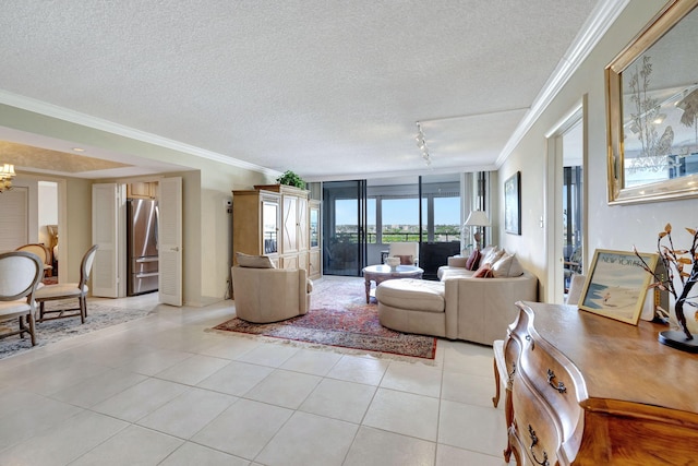 living room with light tile patterned floors, ornamental molding, rail lighting, and a textured ceiling