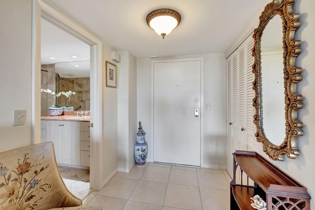 entryway featuring sink and light tile patterned floors