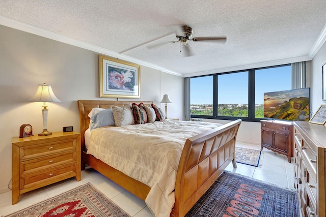 bedroom with crown molding, light tile patterned flooring, ceiling fan, and a textured ceiling