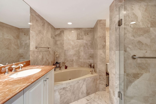 full bathroom featuring vanity, toilet, separate shower and tub, and tile walls