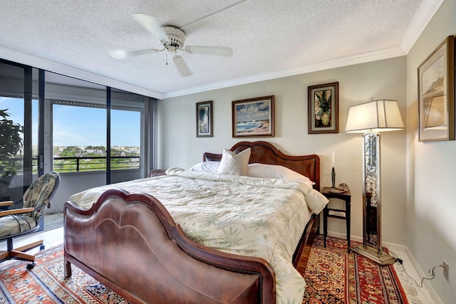 bedroom featuring access to exterior, ornamental molding, a textured ceiling, and ceiling fan