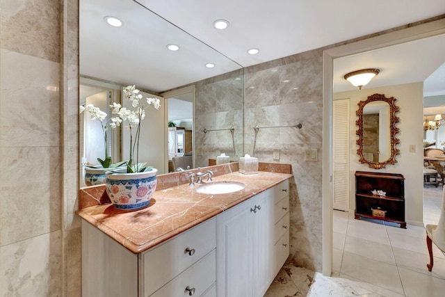 bathroom with vanity and tile walls