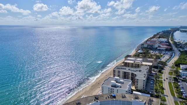 drone / aerial view featuring a water view and a view of the beach