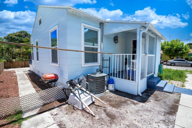 view of side of home with central AC unit