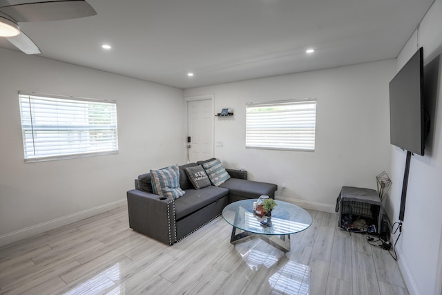 living room featuring ceiling fan and light hardwood / wood-style flooring