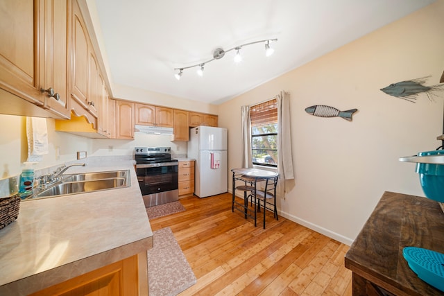 kitchen featuring light wood-style flooring, freestanding refrigerator, a sink, stainless steel range with electric cooktop, and under cabinet range hood