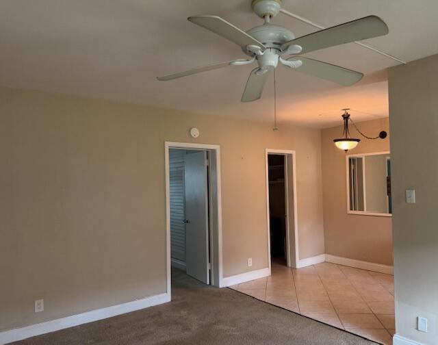 spare room with baseboards and light tile patterned floors