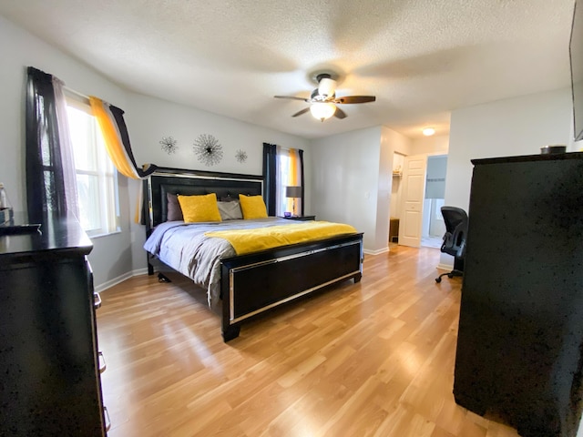 10586 Pelican Dr, Wellington, FL 33414 - bedroom with light wood-style flooring, a textured ceiling, baseboards, and ceiling fan