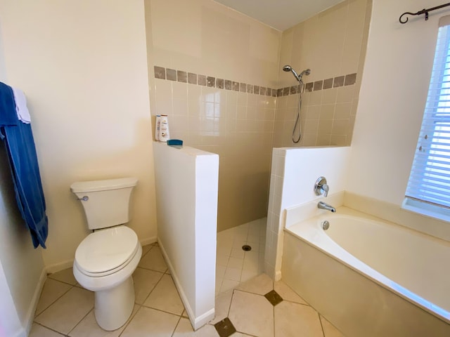 bathroom with a garden tub, toilet, a walk in shower, tile patterned flooring, and baseboards