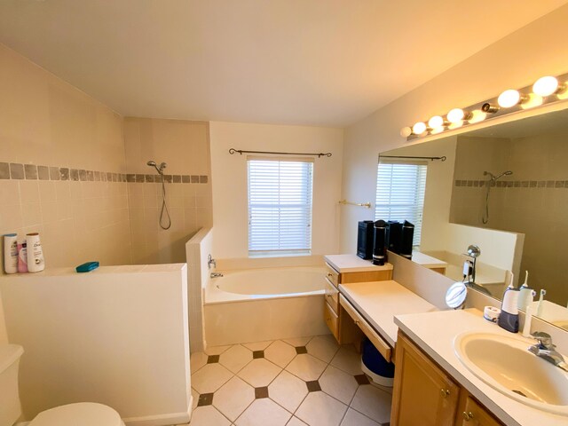 10586 Pelican Dr, Wellington, FL 33414 - bathroom with tile patterned floors, toilet, tiled shower, a garden tub, and vanity