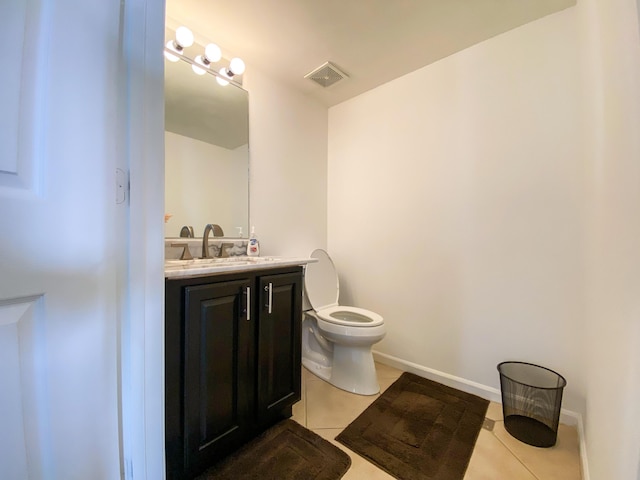 half bath with visible vents, baseboards, toilet, tile patterned flooring, and vanity