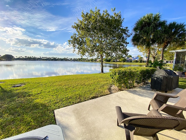 view of patio / terrace featuring a water view and a grill