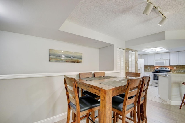 dining area with a textured ceiling