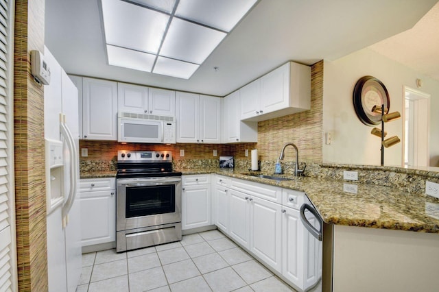 kitchen featuring stainless steel appliances, white cabinetry, stone countertops, and sink