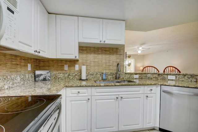 kitchen featuring sink, white cabinetry, light stone counters, kitchen peninsula, and dishwasher