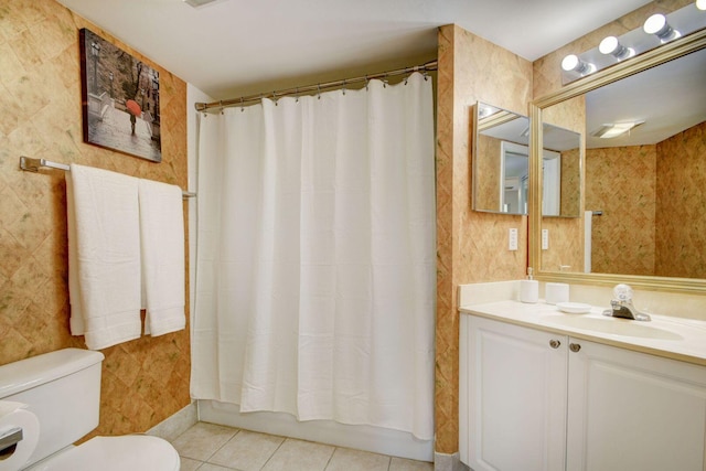 full bathroom featuring shower / bath combination with curtain, tile patterned floors, toilet, and vanity