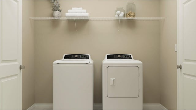 clothes washing area featuring independent washer and dryer