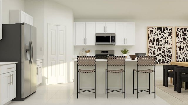 kitchen with white cabinetry, stainless steel appliances, and a breakfast bar