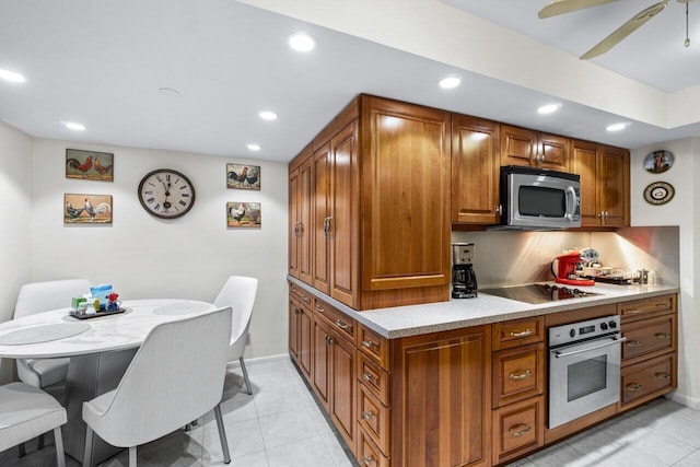 kitchen with light tile patterned floors, ceiling fan, and appliances with stainless steel finishes