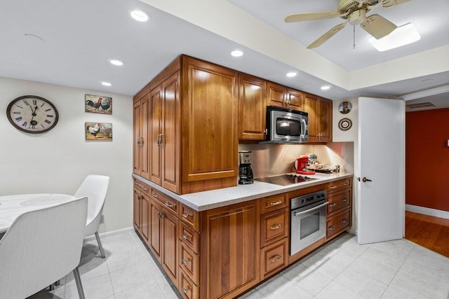 kitchen featuring light tile patterned flooring, appliances with stainless steel finishes, and ceiling fan