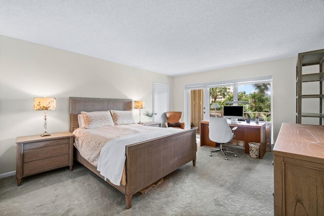 bedroom featuring carpet flooring and a textured ceiling