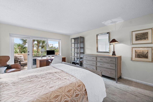 carpeted bedroom with access to outside and a textured ceiling