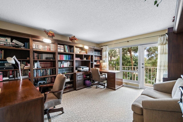 carpeted home office with a textured ceiling