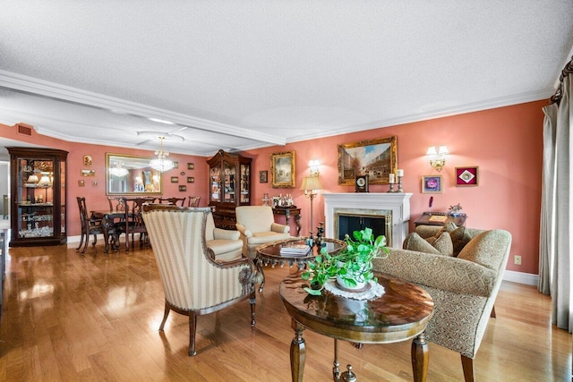 living room with hardwood / wood-style floors, a fireplace, and a textured ceiling