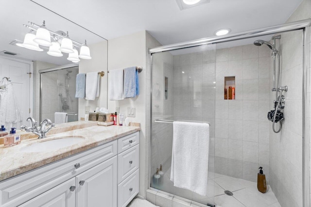 bathroom featuring vanity and a shower with shower door