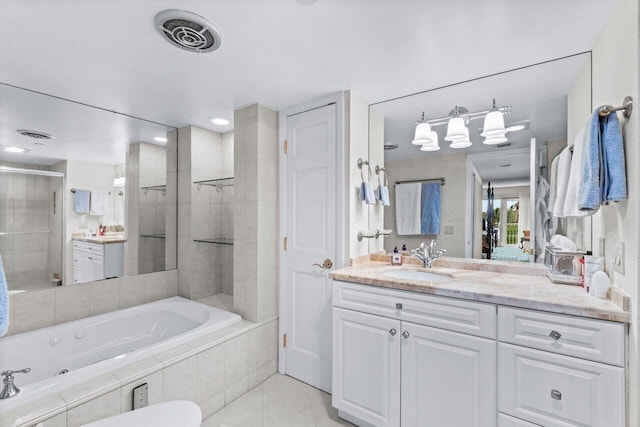 bathroom featuring tile patterned flooring, vanity, and separate shower and tub