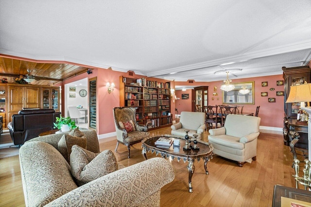 living room featuring a notable chandelier, crown molding, light hardwood / wood-style flooring, and a textured ceiling