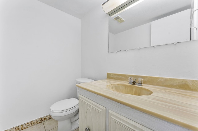 bathroom featuring vanity, tile patterned floors, and toilet