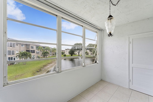 unfurnished sunroom with a water view