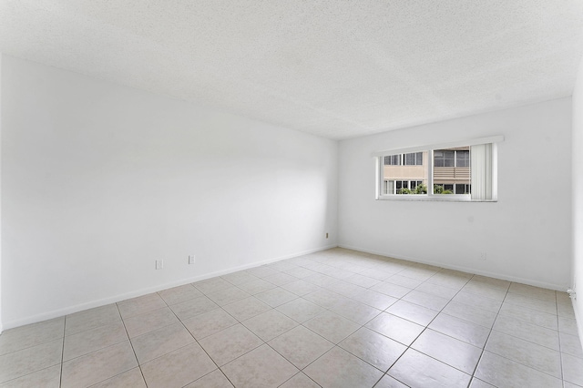 unfurnished room featuring a textured ceiling