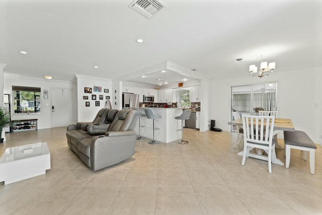 tiled living room with crown molding and a notable chandelier