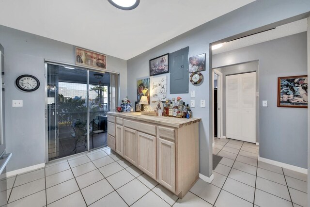 kitchen featuring sink, light tile patterned floors, appliances with stainless steel finishes, decorative light fixtures, and a chandelier