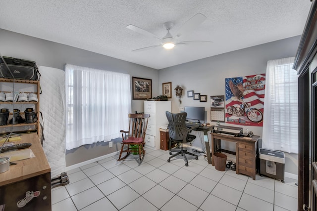 office space featuring ceiling fan, a textured ceiling, and light tile patterned floors