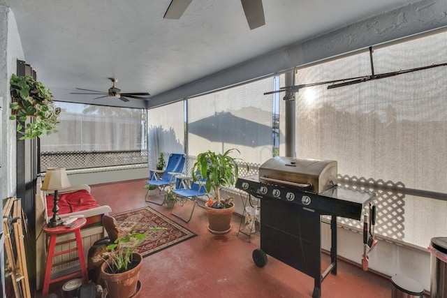 sunroom / solarium featuring ceiling fan